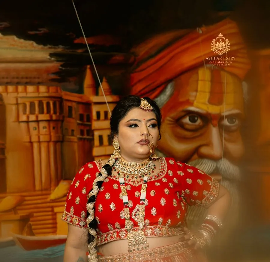 Bridal portrait in a red lehenga at a heritage archway