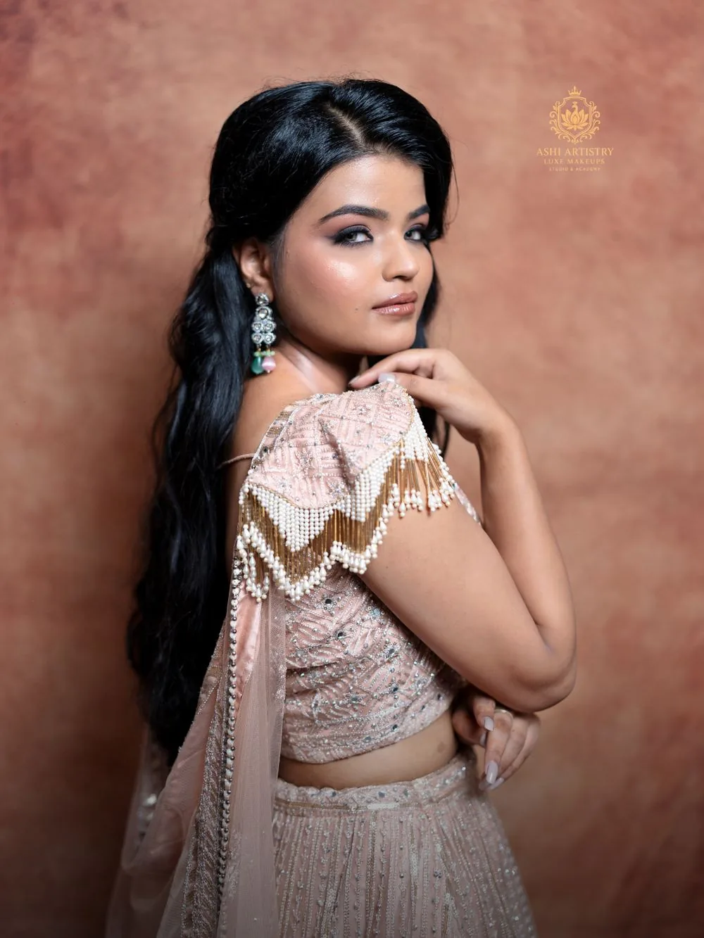 Editorial portrait in a blush lehenga, back view